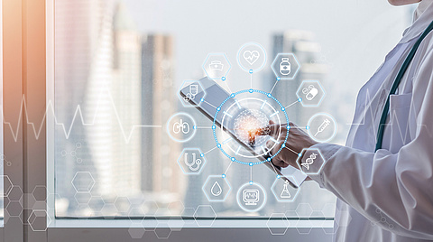 Arzt hält Tablet in der Hand mit visuellen Icons