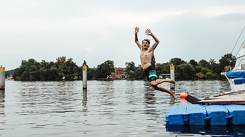 Jugendlicher springt ins Wasser